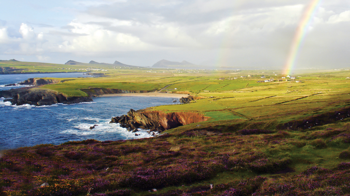 The landscape and ocean on the Dingle Peninsula, with a rainbow.